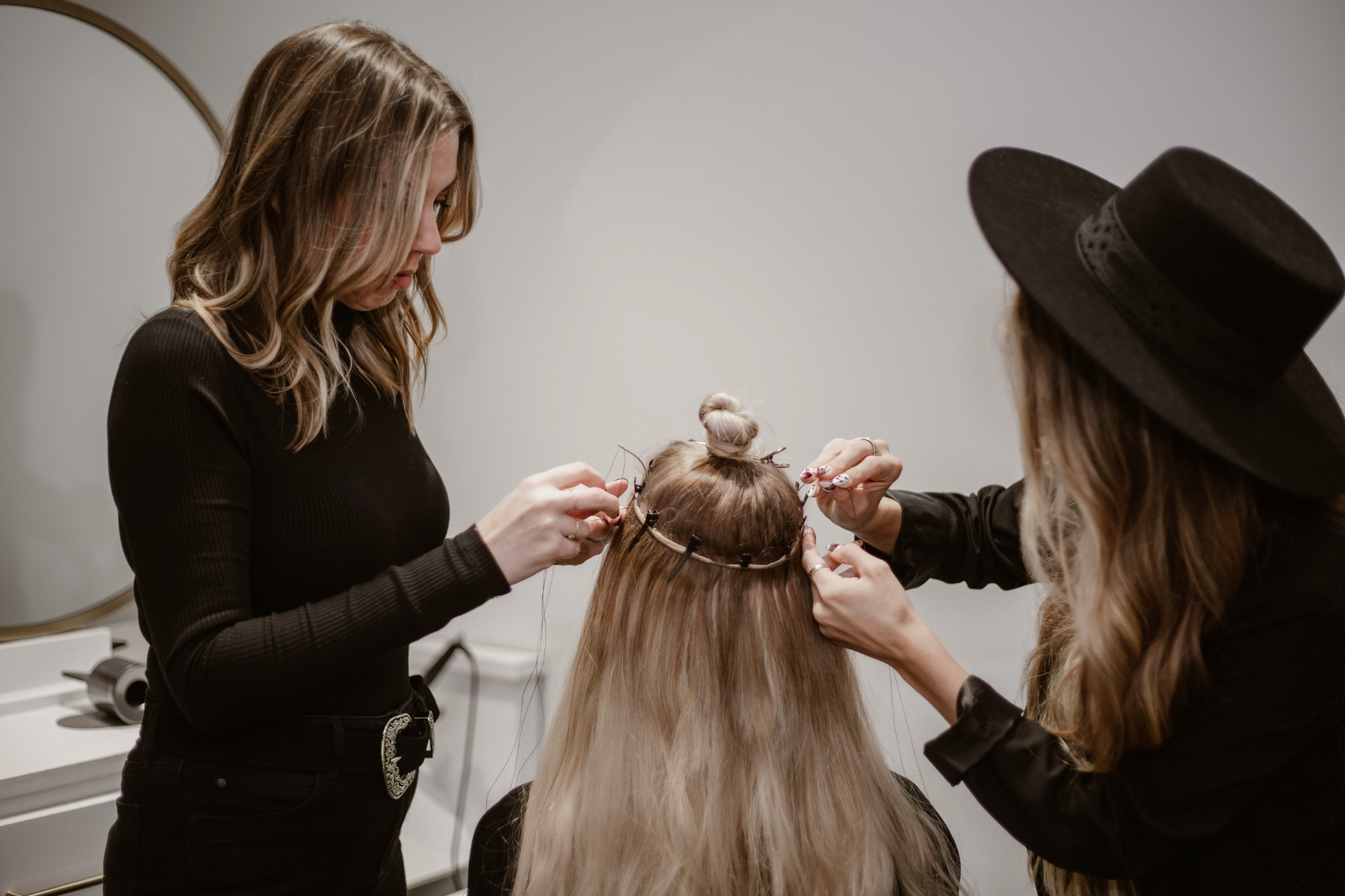 Stylist working on long hair, highlighting technique and detail