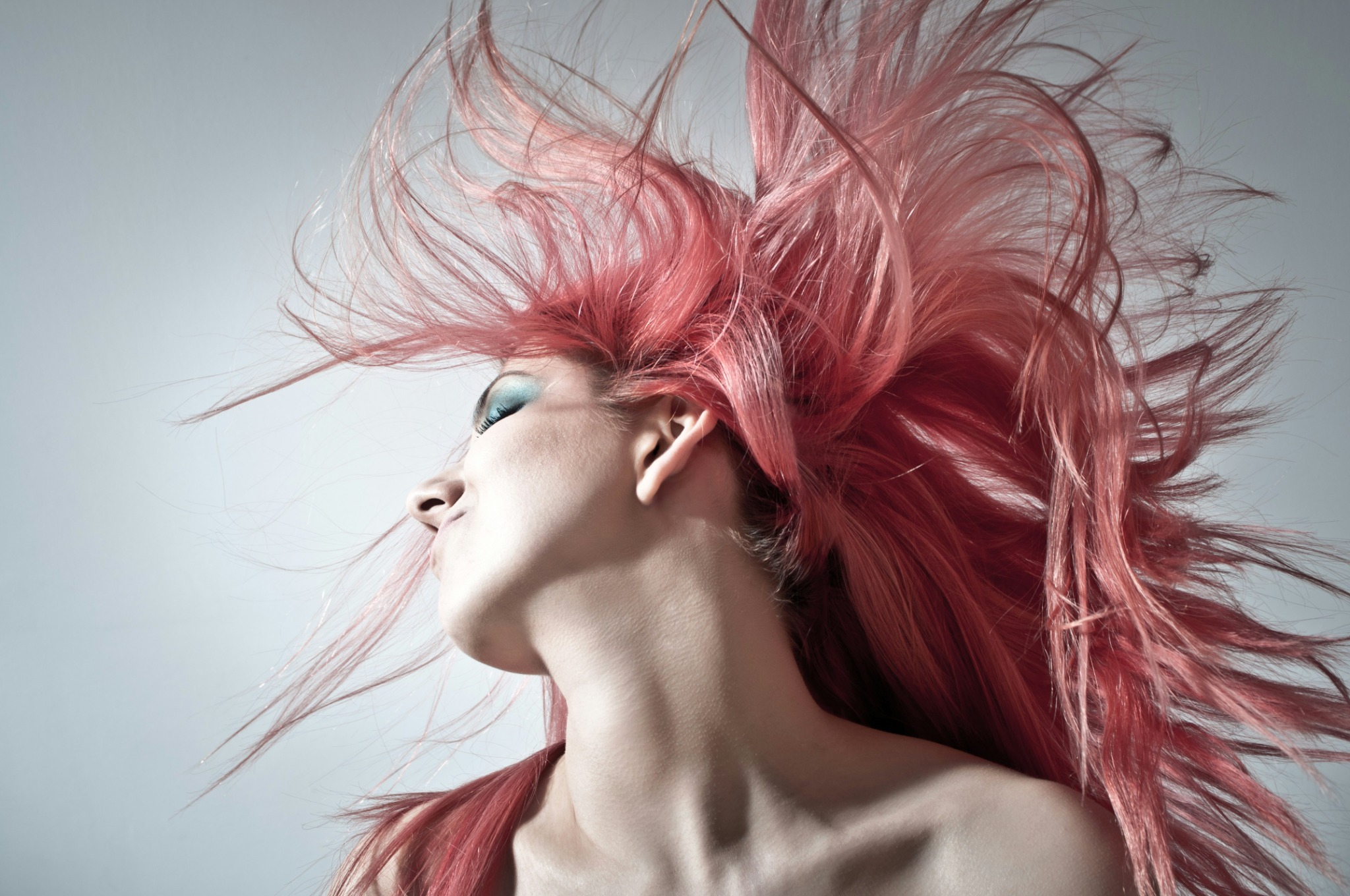 Bold pink fashion hairstyle in an editorial setting